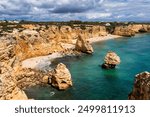 Praia da Marinha, beautiful beach Marinha in Algarve, Portugal. Navy Beach (Praia da Marinha) with flying seagulls over the beach, located on the Atlantic coast in Lagoa Municipality, Algarve.