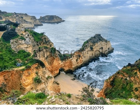 Praia do submarino, Alvor, Portugal, Algarve. Rocks, rocky shore, yellow rocks, coquina, beautiful coastline