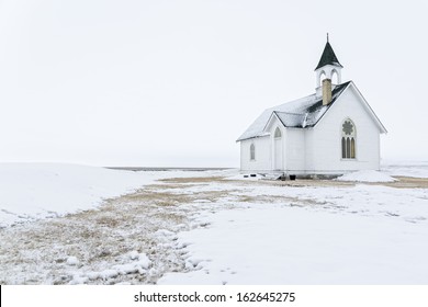 Prairie church on a foggy winter day 