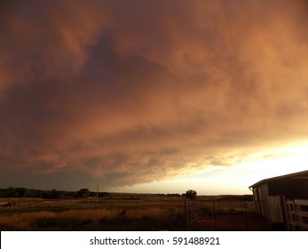 Prairie Dust Storm Rolling In, Orange And Dark, Over A Western Nebraska Farm In Summer