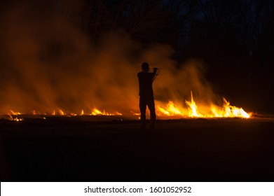 Prairie Fire At Night With Silhouette