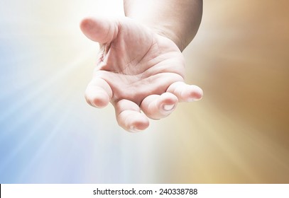 Praise and worship concept: Christian open hand with palm up on spiritual light background