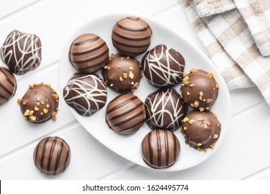 Praline Bonbons. Chocolate Truffles On Plate On White Table. Top View.