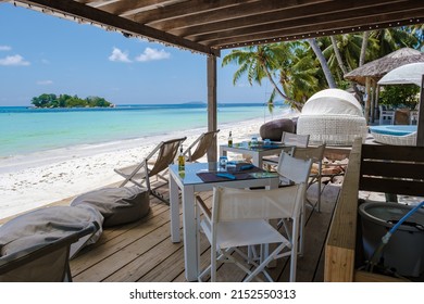 Praslin Seychelles tropical island with withe beaches and palm trees, restaurant with chairs on the beach of Anse Volbert Seychelles. 