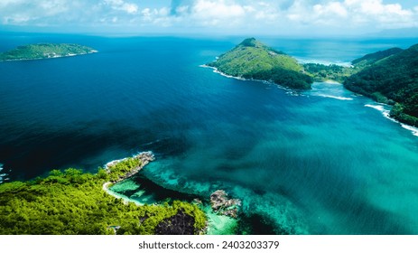 Praslin Seychelles tropical island with withe beaches and palm trees. Top view of a beautiful bay in the Indian Ocean with turquoise crystal clear waters