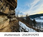 Prattsville, NY, USA - Dec 27, 2024. Uphill, short mountain hike to Pratt Rock. Mount Rushmore of upstate New York. Stone carving made by Zadock Pratt. Nearby dog and horse tombstone, view of valley.