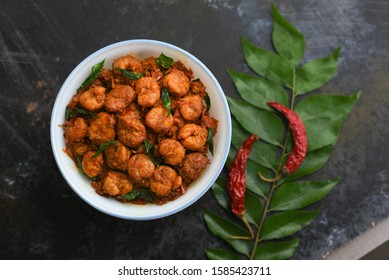 Prawns, Chemmeen roast shrimp fry Kerala fish curry prawns Masala, spicy grilled shrimp on dark black background in South India. Top view popular Indian non veg food side dish for rice, Chapati