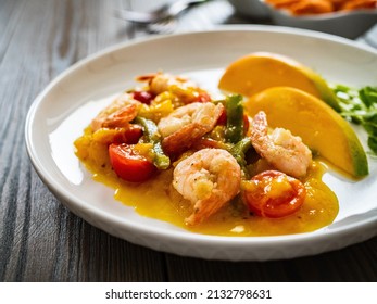 Prawns In Mango Sauce On Wooden Table 