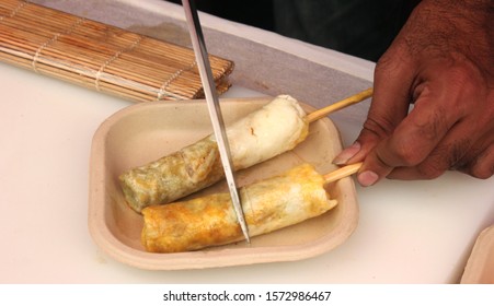 Prawns/Shrimp Stuffed Egg Roll Made Using A Roll Maker,  A Chef Cuts The Roll Gently And Checks The Freshness And The Texture Inside The Roll.