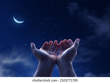 Pray muslim, hands open to the sky in the holly night. - Shutterstock ID 2103771785