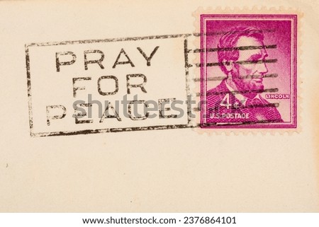 Pray for peace postmark cancellation stamp on an aged postcard with copy space