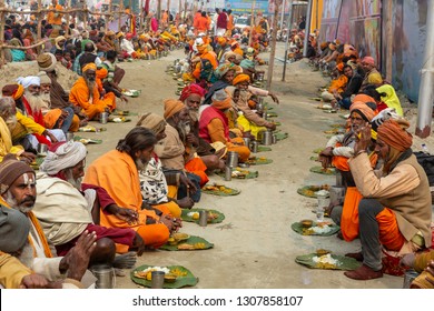 Prayagraj (formerly Allahabad), India - January 13, 2019: Sadhus Eating The Food Offered By Devotees As A Donation Or Charity During  Kumbh Mela, 2019, Prayagraj. It Is Open To Everyone.