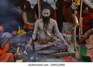 Prayagraj, Uttar Pradesh, India 16 January, 2019: Portrait of Naga Sadhu smoking at the Kumbh Mela a hindu festival , sadhus followers of Shiva often smoke marijuana. Prayagraj, Uttar Pradesh, India