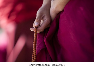 Prayer beads in monk's hand