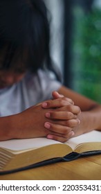 Prayer And Bible Concept. Asian Kid Praying, Hope For Peace And Free From War And Coronavirus, Hand In Hand Together By Child. Little Girl Believes And Faith In Christian Religion At Church-vertical