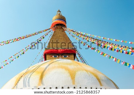 Prayer buddhist flags fluttering in the wind on the Boudhanath stupa in Kathmandu, Nepal.