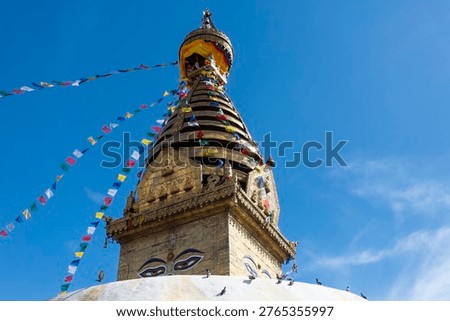 Prayer buddhist flags fluttering in the wind on the Swayambhunath stupa in Kathmandu, Nepal.