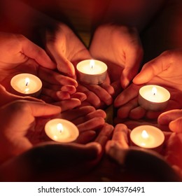 Prayer With Candles In Hands