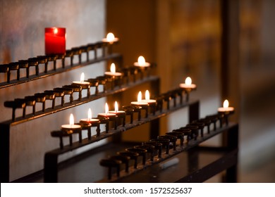 Prayer Candles Lit Inside A Church As A Votive Offering In An Act Or Prayer