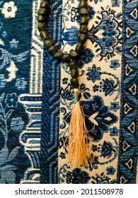 Prayer Equipments For Muslim Includes Prayer Mat And Prayer Beads With 99 Pieces. The Beads Made Of Uniquely Large Seeds From Banana Plant That Grows Near Wali Sunan Bonang Tomb In East Java. 