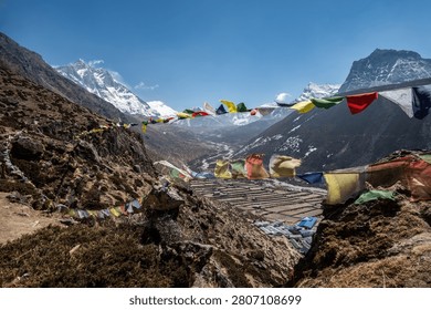 Prayer flags hanging on the viewpoint in Dingboche village, Nepal. Prayer flags at a viewpoint symbolize peace, compassion, and good fortune.