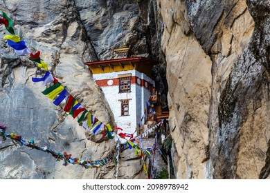 Prayer flags and a small monastery in the mountains around the Tiger's Nest monastery (Taktshang Goemba) in Paro, Bhutan, Asia