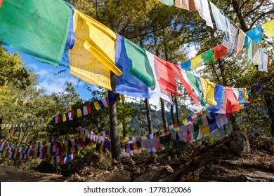 Prayer flags in the wind - Hiking trail to Paro Taktsang, Tiger's Nest Monastery, Paro Valley - Bhutan in late Autumn. 