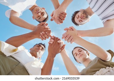 Prayer Is The Key To A Successful Day. Shot Of A Group Of Young People Holding Hands While Praying Outside.