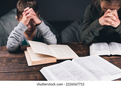 Prayer. People are sitting at the table with their hands in prayer. Open Bible. Pray to God - Shutterstock ID 2226567715