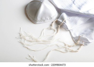 Prayer shawl tallit and kippah (religious hat). Jewish national and religious tallith katan - in the form of a cape with brushes. Still Life of Jewish symbols for Sukkot, shabbat, rosh hashanah.