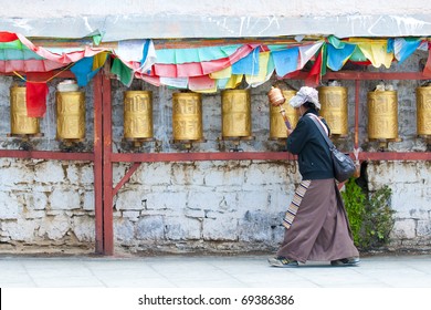 Prayer wheels along a pilgrim route in Lhasa, Tibet (Potala Palace)