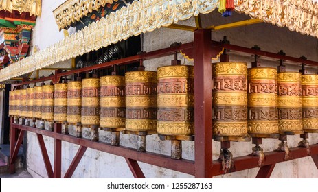 Prayer wheels in Jokhang temple. The characters (in Newari language & Tibetan) on the wheels are the mantras "Om Mani Padme Hum", each word means "sacred, bead, lotus flower, spirit of enlightenment"