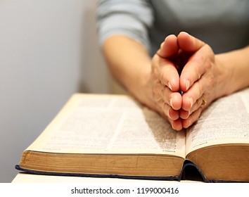  praying hands with bible on white background stock photo