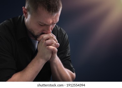 Praying Hands With Faith In Religion Belief In God On Dark Background.