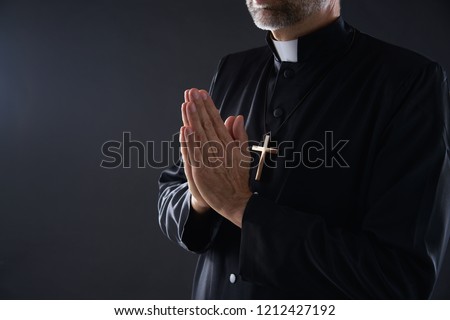 Praying hands priest portrait of male pastor
