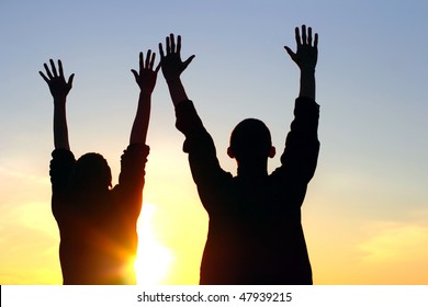 Praying People Silhouette On Sunset Background