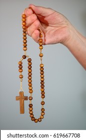 Praying with rosary, hand holding rosary, isolated hand and rosary