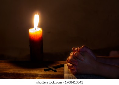 Praying Woman Hands On Old Holy Bible Sacred Book In A Dark Church During A Prayer Worship Service With Religious Candles Glowing, Religion And Faith Concept