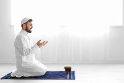 Praying Young Muslim Man At Home