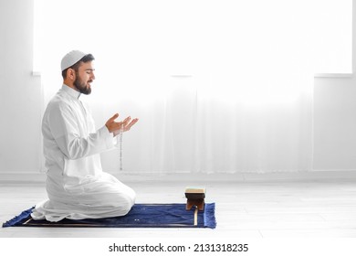 Praying young Muslim man at home - Powered by Shutterstock