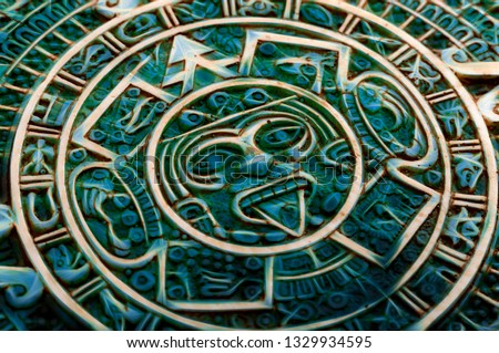 Pre Columbian culture and indigenous civilizations concept them with close up on a aztec sun calendar made of semi precious jade stone