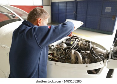 Pre Flight Check Or Maintenance On A Small Aircraft In A Hangar