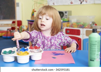 Pre School Child Painting Picture In Classroom