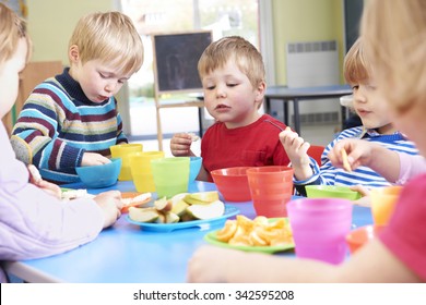 Pre School Children Eating Healthy Snacks At Breaktime