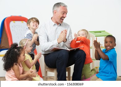 Pre School Teacher Reading Story To Children And Praying