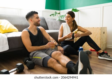 Pre Workout Snack. Attractive Boyfriend And Girlfriend Eating Fruit And Drinking Juice Before Their Home Workout 