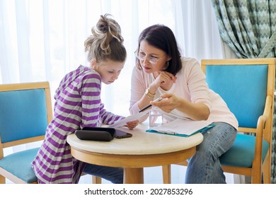 Pre-adolescent Girl At Consultation With Social Worker In Office