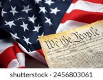 Preamble to the Constitution of the United States and American Flag. Old yellow paper with We The People text