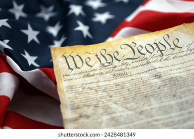 Preamble to the Constitution of the United States and American Flag. Old yellow paper with We The People text - Powered by Shutterstock