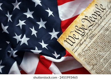 Preamble to the Constitution of the United States and American Flag. Old yellow paper with We The People text - Powered by Shutterstock